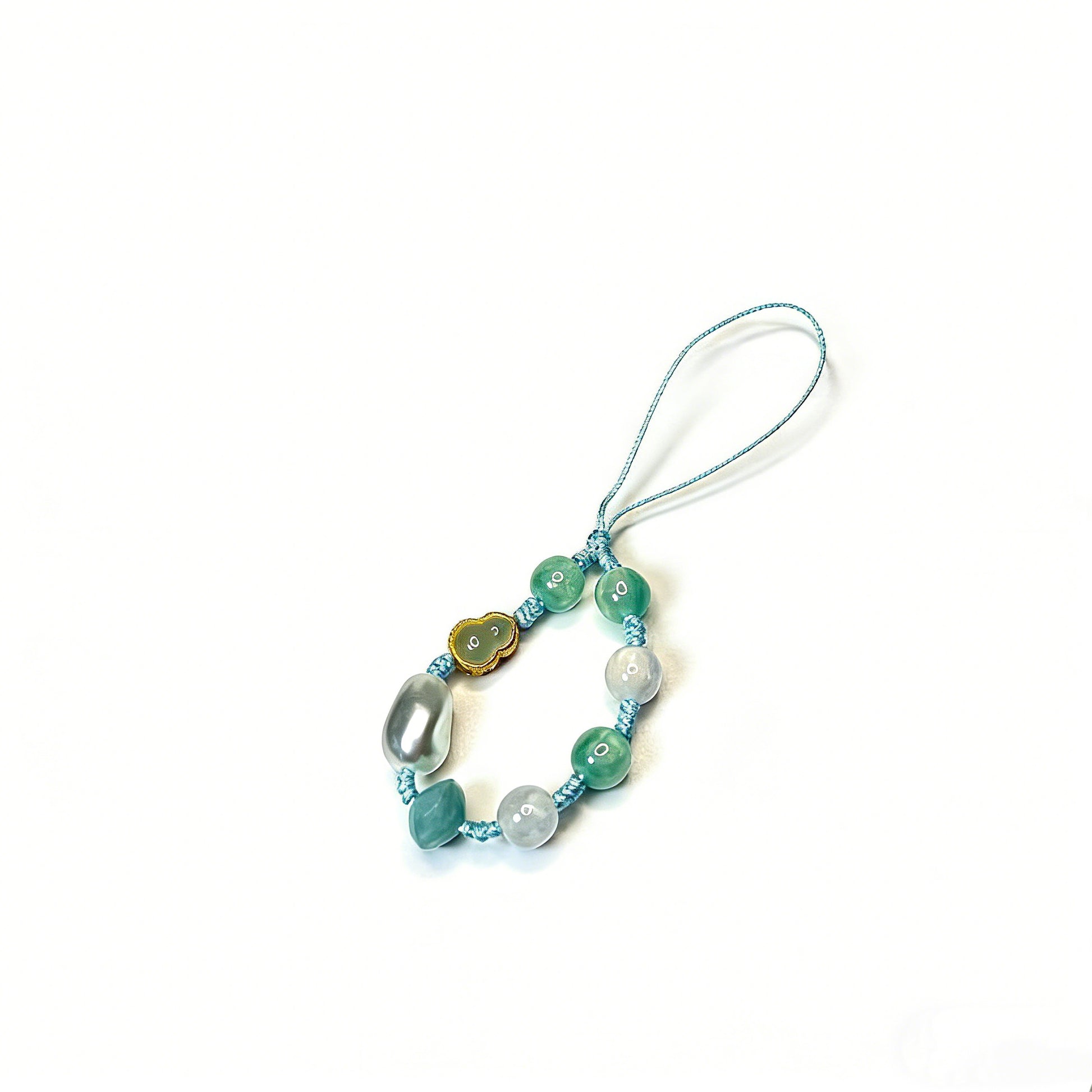 Handmade lucky phone charm with green jade beads, a cloud-shaped jade pendant, and silver pearls hand-knotted on a light blue cord by Case not Cake.