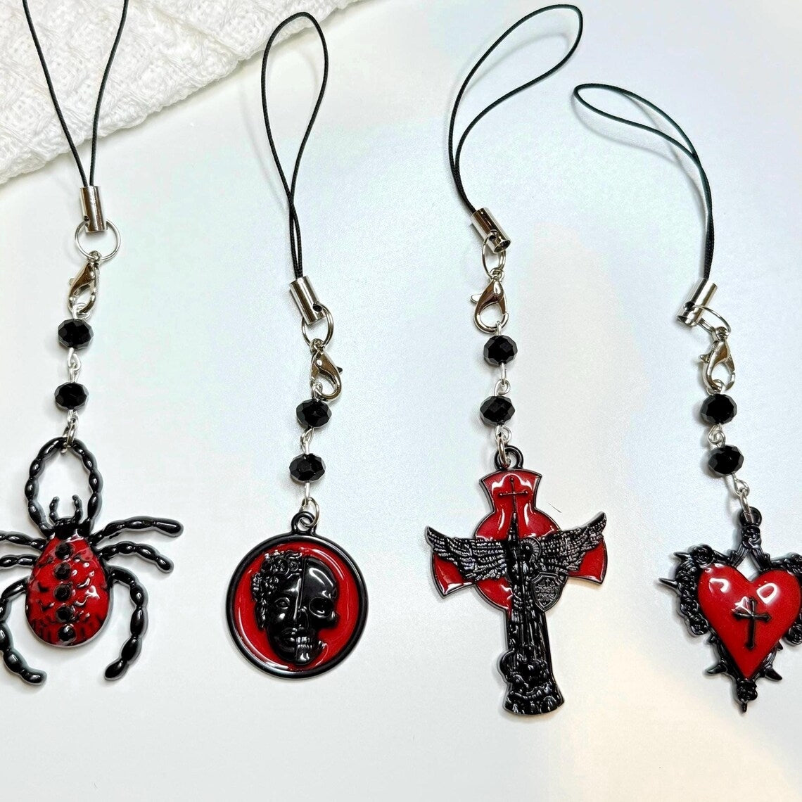 Four gothic black and red phone chains with unique designs